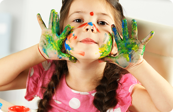 preschool child with paint on hands